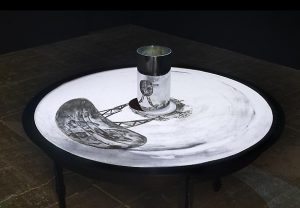 William Kentridge What Will Come, 2007. Anamorphic projection: 35mm film transferred to DVD; 8min, 40sec. Cold rolled steel table and cylinder, 107.95 x 121.92 cm